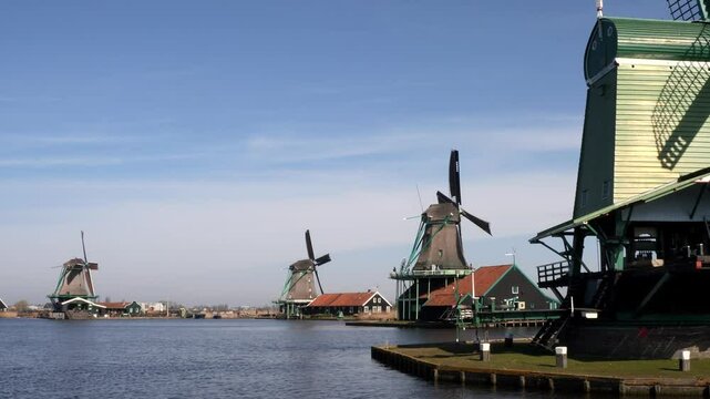 Historic mills at the Zaanse Schans on the River Zaan on a sunny day in North Holland, Netherlands