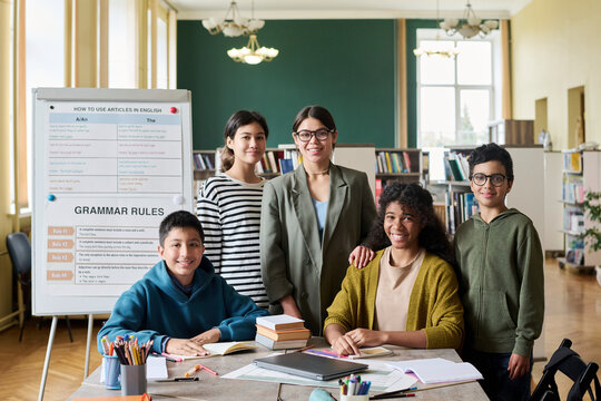 Group portrait of a teacher and students in a classroom setting - Powered by Adobe