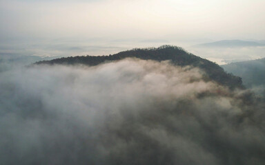 Aerial view landscape of fog flowing on mountains in the morning by drone