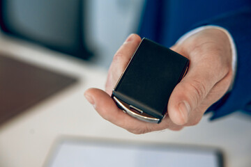 Salesman hand giving keys to client at showroom