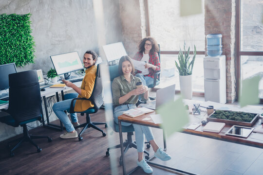 Young diverse team working together in a bright modern office space, enjoying collaboration and teamwork - Powered by Adobe