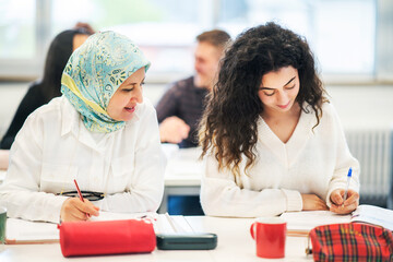 Women studying together in a classroom with a positive and collaborative atmosphere