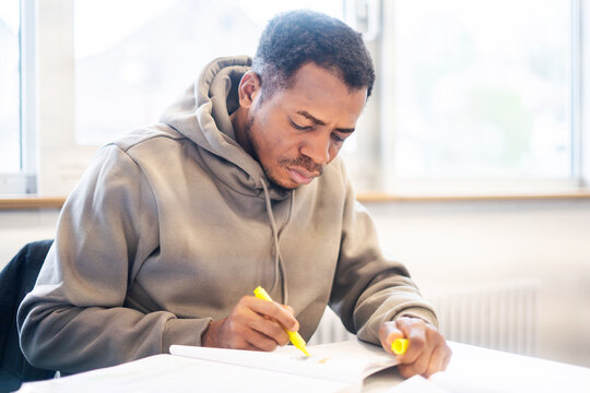 Student focused on learning in a multicultural classroom setting