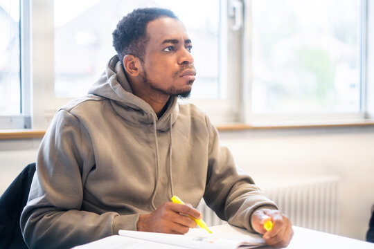 Student focused on learning in a multicultural classroom setting