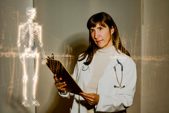 Doctor examining a 3D render of a human skeleton with a clipboard