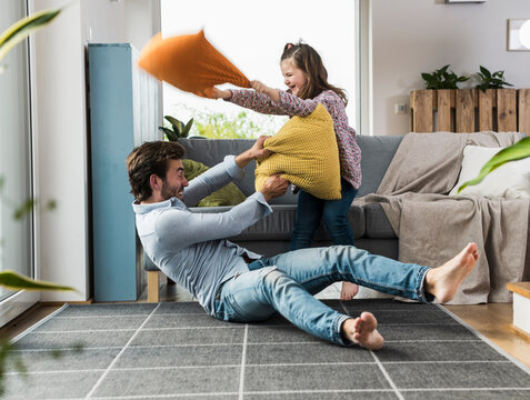 father,daughter,at home,having fun,love,quality time,inspiration,trust,security,care,pillow fight