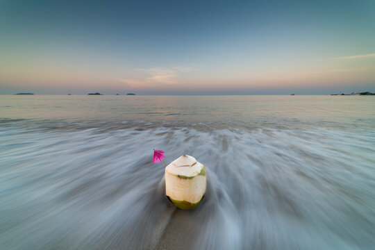 Coconut at sunrise on the beach of Koh Changi Island, Andaman Sea, South Thailand