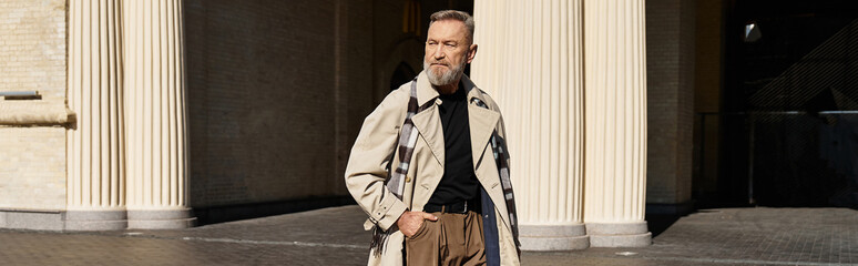A handsome senior man strolls through a chic cityscape, exuding confidence and style.