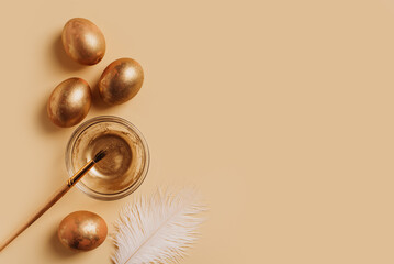 Easter concept background with golden eggs, feather