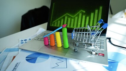Creative Business Analysis with Clay Graph and Rocket Model, A laptop keyboard with colorful clay bar graph and rocket model, business charts in background - Powered by Adobe