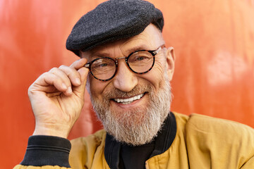 A chic older man showcases his fashion sense while walking through a bustling city.