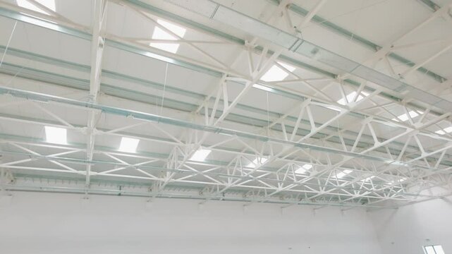 White industrial ceiling structure with skylights in modern building