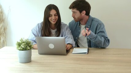 Young couple seated at a table with a laptop and scattered papers, collaboratively drafting notes that include a shopping list and vacation plans, while engaging in remote digital work - Powered by Adobe