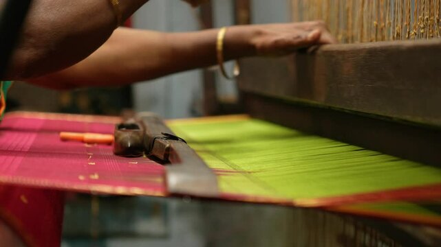 Moving Camera Footage of Traditional Handloom Weaving with Flowing Threads.