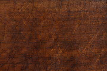 Brown wooden background with knife carvings