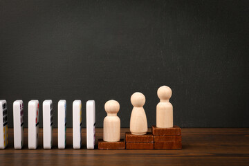 Domino Effect Concept with Wooden Figures Representing Growth and Progress