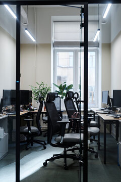 Modern office workspace with computers, desks, and chairs