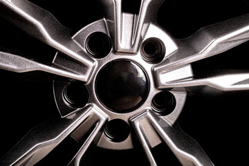 wheel. black background. car wheel with tire. disk is smelted from titanium. close-up. there is...