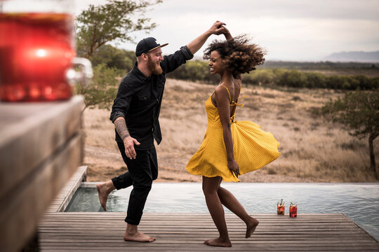 Happy couple dancing on deck of a lodge, Cape Town, South Africa