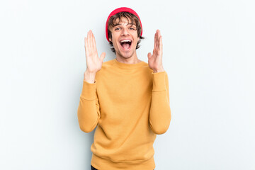 Young caucasian man isolated on blue background laughs out loudly keeping hand on chest.