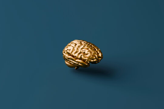 Golden brain floating against a blue background symbolizing creativity and innovation