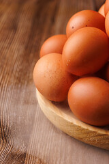 Rustic plate with brown eggs veiled in mist, illustrating global food price surge and economic hardship in households.