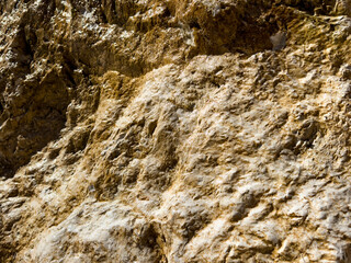 high-resolution texture of a natural rock surface. rough details. earthy tones, geological background. beige tones. calm tones. design, architecture