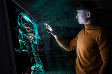 Young man interacting with augmented reality medical display