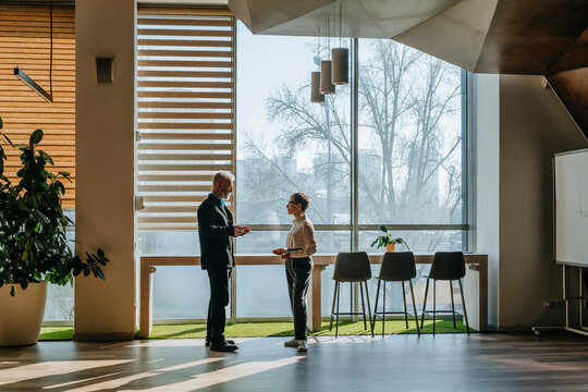 Business people having a conversation in a modern coworking space