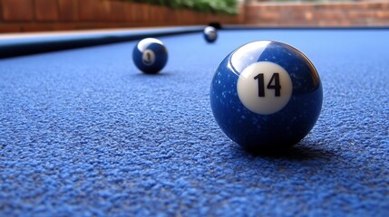 Close-up of billiard balls on a blue pool table.