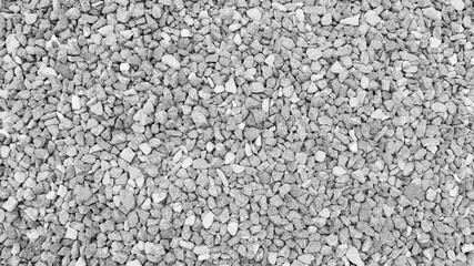 close-up view of crushed gray gravel, showcasing a rough and natural stone texture ideal for backgrounds, construction landscaping and industrial design elements.