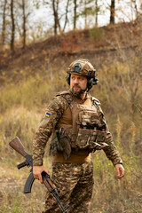 Soldier of Ukraine with assault rifle and flag of Ukraine on military uniform. Ukrainian soldier...