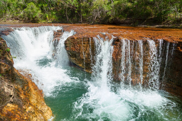 Eliot falls cascades beautifully over a rock ledge on Eliot creek into the pristine water below at this popular tourist spot on Cape York in the tropical far north of Queensland, Australia. © Shirley and Johan