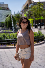 Young female tourist strolling down a street in Los Angeles, California.