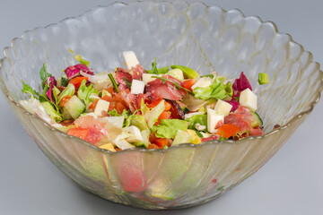 Vegetable salad with avocado, mozzarella and dry-cured sausage