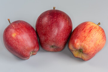 Red apples on a gray background close-up