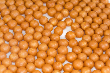 Dragee layer with honey and other beekeeping products close-up