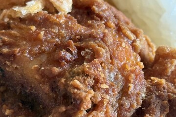 Close up of fried chicken with rice on the table in a cafe or restaurant.