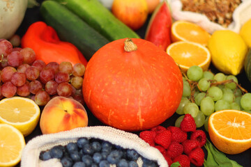 Various healthy fruits, vegetables and cereals on dark background. Selective focus.