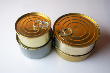 Round tin cans with food on the surface