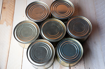 Round tin cans with food on the surface