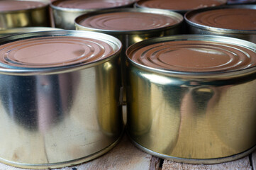 Round tin cans with food on the surface