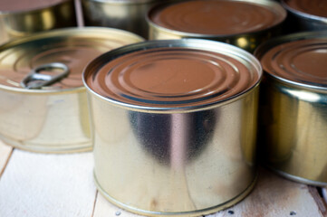 Round tin cans with food on the surface