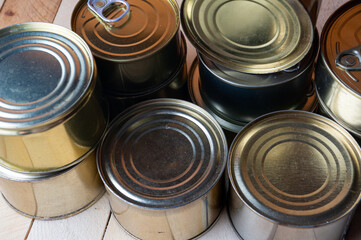 Round tin cans with food on the surface