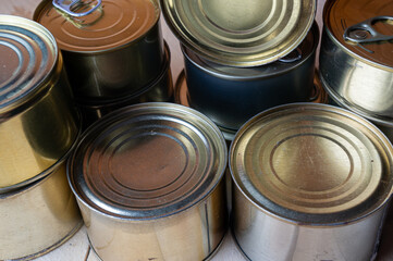 Round tin cans with food on the surface