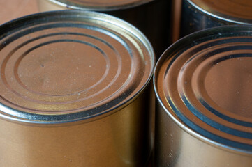 Round tin cans with food on the surface