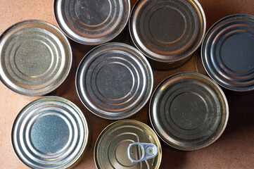 Round tin cans with food on the surface