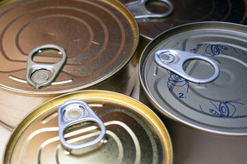 Round tin cans with food on the surface