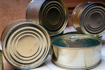 Round tin cans with food on the surface
