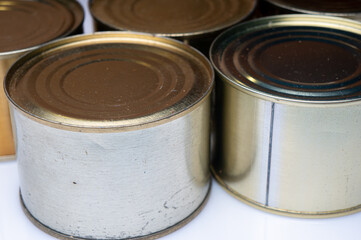 Round tin cans with food on the surface
